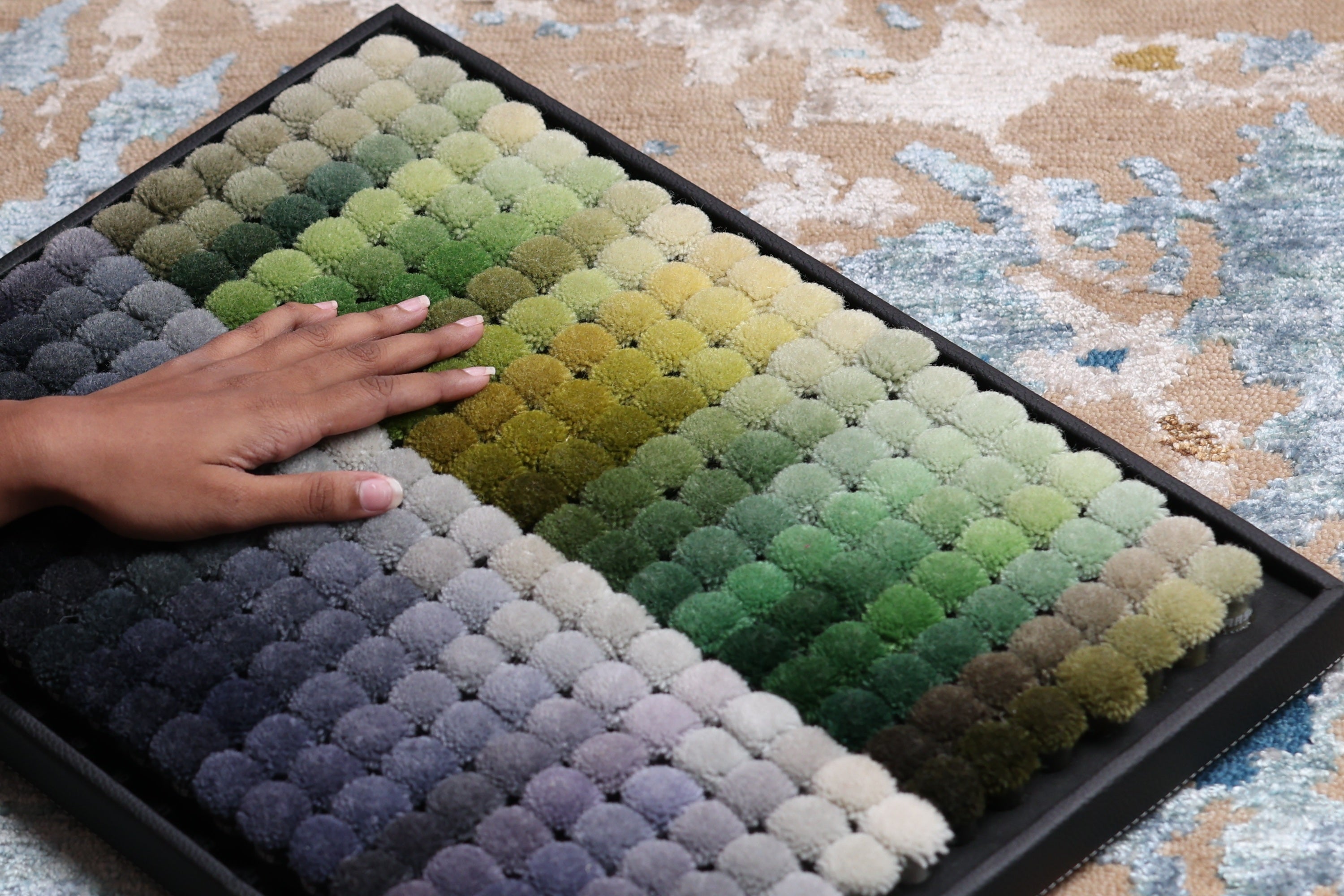 Designer selecting the color for a custom rug design